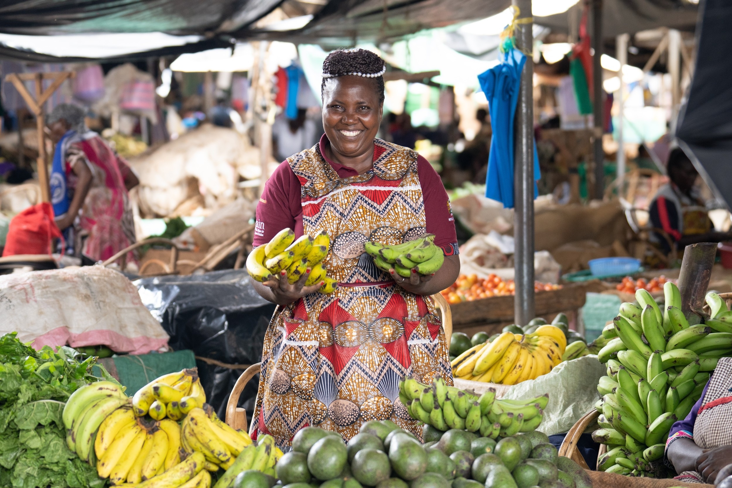 vendor displaying fruits and vegetables at her stall